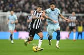 Bruno Guimaraes of Newcastle United is challenged by Lloyd Kelly of AFC Bournemouth during the Premier League match between Newcastle United and AFC Bournemouth at St. James Park on February 17, 2024 in Newcastle upon Tyne, England.