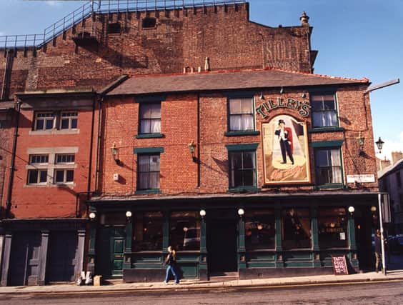 A 1995 photograph of Tilley's restaurant at the junction of Westgate Road and Thornton Street. The view is of the side of Tilley's on Thornton Street. To the left are the exits for the Stalls and Gallery of the Tyne Theatre.