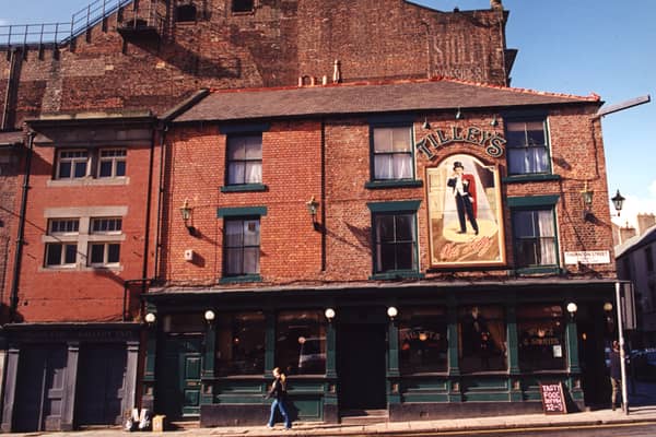A 1995 photograph of Tilley's restaurant at the junction of Westgate Road and Thornton Street. The view is of the side of Tilley's on Thornton Street. To the left are the exits for the Stalls and Gallery of the Tyne Theatre.