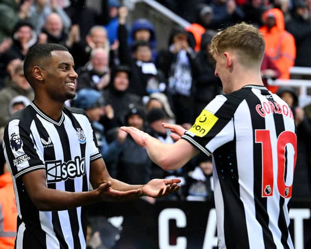 Alexander Isak of Newcastle United celebrates scoring his team's first goal with teammate Anthony Gordon during the Premier League match between Newcastle United and Wolverhampton Wanderers at St. James Park on March 02, 2024 in Newcastle upon Tyne, England.