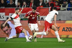Ismail Yuksek (L) challenges Dominik Szoboszlai