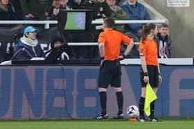 Referee Sam Allison studies the pitchside monitor before awarding Everton a penalty against Newcastle United