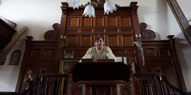 Wayne Colquhoun stands at the pulpit in the former Chapel Salem.