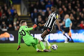 Alexander Isak of Newcastle United is challenged by Dean Henderson of Crystal Palace during the Premier League match between Crystal Palace and Newcastle United at Selhurst Park on April 24, 2024 in London, England. 