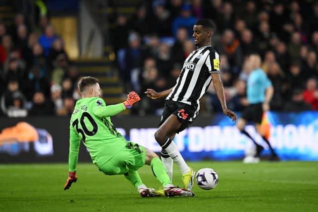 Alexander Isak of Newcastle United is challenged by Dean Henderson of Crystal Palace during the Premier League match between Crystal Palace and Newcastle United at Selhurst Park on April 24, 2024 in London, England. 