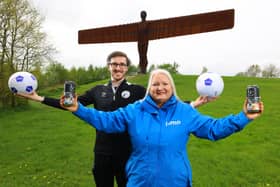 Jack McGraghan from Gateshead FC, with Gillian Morton, head of customer experience at Lumo, holding the commemorative cans.