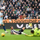 Dominic Solanke goes for goal against Newcastle, but his shot is saved by Martin Dubravka