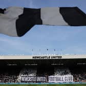 Fans of Newcastle United show their support with banners and flags prior to the Premier League clash against Brighton. (Photo by George Wood/Getty Images)