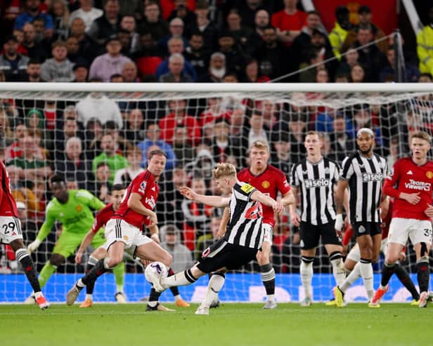 Lewis Hall of Newcastle United scores his team's second goal during the Premier League match between Manchester United and Newcastle United at Old Trafford on May 15, 2024 in Manchester, England. 