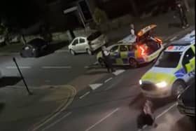 A still from a video uploaded by X account UB1UB2 West London (Southall) of a cow being rammed by a police car in Feltham on June 14, 2024 