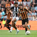 Jamal Lewis (L) of Newcastle United in action with Abdus Omur of Hull City during the Pre-Season Friendly between Hull City and Newcastle United at MKM Stadium on July 27, 2024 in Hull, England.