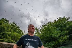 Gary Hough, 62, looks up to the skies outside his home surrounded in seagull