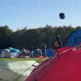 Tent hurtles across sky as Storm Lilian hits Leeds Festival.