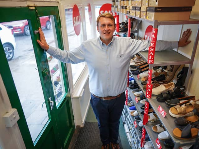 Oliver Salter, 31, who owns Peter Scott shoe shop in Woodhall Spa, Lincolnshire, Britain's smallest shoe shop.