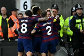 Newcastle United's English midfielder #11 Harvey Barnes is mobbed by teammates after scoring the teams second goal during the English Premier League football match between Wolverhampton Wanderers and Newcastle United at the Molineux stadium in Wolverhampton, central England on September 15, 2024.