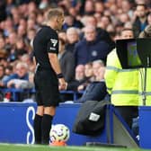 Referee Craig Pawson reviews the VAR monitor during the Premier League match between Everton FC and Newcastle United FC at Goodison Park on October 05, 2024 in Liverpool, England. (Photo by Jan Kruger/Getty Images)