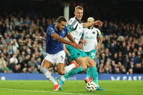 Dominic Calvert-Lewin of Everton is challenged by Dan Burn of Newcastle United during the Premier League match. Photo by Matt McNulty/Getty Images)