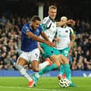 Dominic Calvert-Lewin of Everton is challenged by Dan Burn of Newcastle United during the Premier League match. Photo by Matt McNulty/Getty Images)