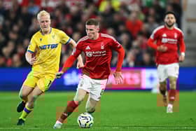 Elliot Anderson of Nottingham Forest runs with the ball whilst under pressure from Will Hughes of Crystal Palace. . (Photo by Michael Regan/Getty Images)