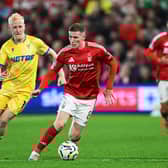 Elliot Anderson of Nottingham Forest runs with the ball whilst under pressure from Will Hughes of Crystal Palace. . (Photo by Michael Regan/Getty Images)