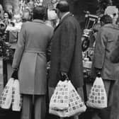 Shoppers pictured looking at a Christmas display in the window of a Marks and Spencer shop on 20th December 1976. 