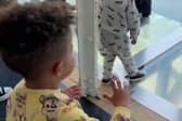 Mason Gee, 3, worried about his father Stephen Gee, 30, walking on a glass walkway