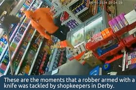 Moment brave shopkeeper fends off armed robber with a mop.