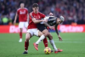 Bruno Guimaraes of Newcastle United is challenged by Ryan Yates of Nottingham Forest during the Premier League match between Nottingham Forest FC and Newcastle United FC at City Ground. (Photo by Naomi Baker/Getty Images)