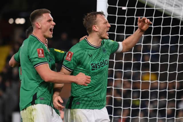 Dan Burn of Newcastle United celebrates with team mate Sven Botman after scoring his team's second goal during the Emirates FA Cup Fourth Round match between Fulham and Newcastle United at Craven Cottage. (Photo by Mike Hewitt/Getty Images)
