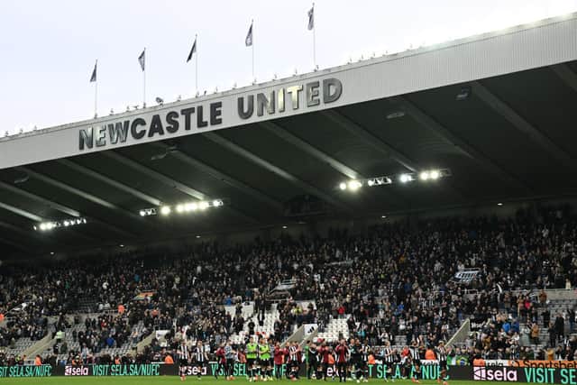 Newcastle's players celebrate with their fans on the pitch after the English Premier League football match between Newcastle United and Arsenal at St James' Park in Newcastle-upon-Tyne, north east England on November 2, 2024. Newcastle won the game 1-0. (Photo by Paul ELLIS / AFP)