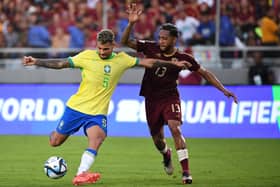 Bruno Guimaraes and Venezuela's midfielder #13 Jose Martinez fight for the ball during the 2026 FIFA World Cup South American qualifiers football match between Venezuela and Brazil at the Monumental stadium in Maturin, Monagas State, Venezuela, on November 14, 2024. (Photo by Federico Parra / AFP) (Photo by FEDERICO PARRA/AFP via Getty Images)