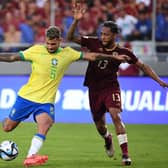 Bruno Guimaraes and Venezuela's midfielder #13 Jose Martinez fight for the ball during the 2026 FIFA World Cup South American qualifiers football match between Venezuela and Brazil at the Monumental stadium in Maturin, Monagas State, Venezuela, on November 14, 2024. (Photo by Federico Parra / AFP) (Photo by FEDERICO PARRA/AFP via Getty Images)