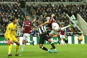 Callum Wilson of Newcastle United is tackled by Konstantinos Mavropanos of West Ham United during the Premier League match between Newcastle United FC and West Ham United FC at St James' Park on November 25, 2024 in Newcastle upon Tyne, England. (Photo by Carl Recine/Getty Images)
