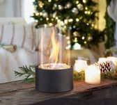 The fireplace can sit in any room, giving off heat and setting a festive mood