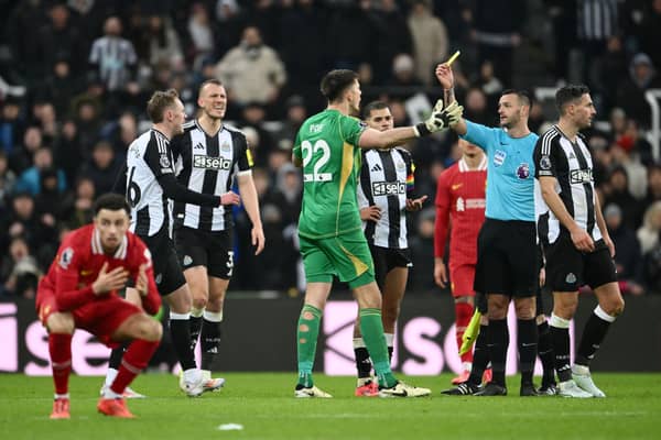 Nick Pope of Newcastle United reacts as he is shown a yellow card by Referee Andy Madley during the Premier League match between Newcastle United FC and Liverpool FC at St James' Park on December 04, 2024 in Newcastle upon Tyne, England. (Photo by Stu Forster/Getty Images)