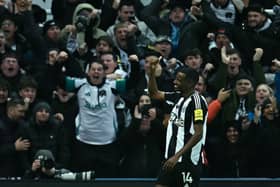 Newcastle United's Swedish striker #14 Alexander Isak celebrates scoring the opening goal against Liverpool. (Photo by Paul ELLIS / AFP) 