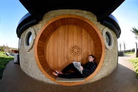 AirB&B host Mike Afflick reads his Lancashire Post while taking a break at his Hobbit House in Inglewhite, near Preston. 