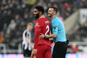 Joe Gomez of Liverpool speaks with Referee Andy Madley during the Premier League match between Newcastle United FC and Liverpool FC. (Photo by Stu Forster/Getty Images)