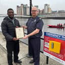 Group Manager Steve Thomas of Tyne and Wear Fire and Rescue Service presenting Okeoghene Eyenre with his commendation for ‘Meritorious Conduct’ on the Newcastle Quayside.   