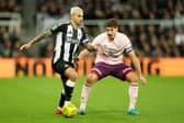 Bruno Guimaraes of Newcastle United controls the ball whilst under pressure from Vitaly Janelt of Brentford.  (Photo by Carl Recine/Getty Images)