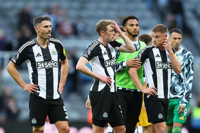 Sean Longstaff of Newcastle United looks dejected with teammates following defeat to Brighton at St James' Park. (Photo by Matt McNulty/Getty Images)