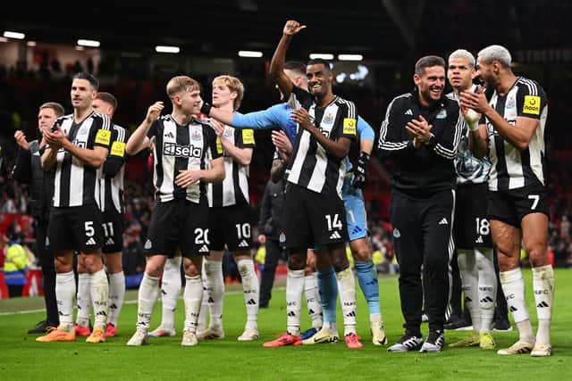 Alexander Isak of Newcastle United, gestures to the fans as he celebrates with his teammates at the end of the Premier League match between Manchester United FC and Newcastle United. (Photo by Stu Forster/Getty Images)