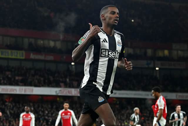 Newcastle United's Swedish striker #14 Alexander Isak celebrates scoring the opening goal during the English League Cup semi-final first leg football match between Arsenal and Newcastle United.  (Photo by GLYN KIRK/AFP via Getty Images)