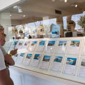 Tourists look at apartments in the window shop of a real estate on the island of Ibiza (Photo: JAIME REINA/AFP via Getty Images)