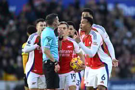 Gabriel of Arsenal and his teammates protest to Referee Michael Oliver after Myles Lewis-Skelly of Arsenal (not pictured) is shown a red card for a foul on Matt Doherty of Wolverhampton Wanderers (not pictured) during the Premier League match between Wolverhampton Wanderers FC and Arsenal FC at Molineux.
