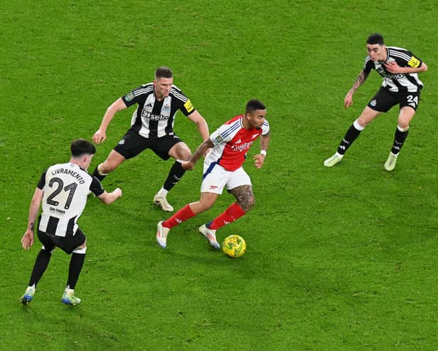 Gabriel Jesus of Arsenal runs with the ball under pressure from Tino Livramento, Sven Botman and Miguel Almirn of Newcastle United during the Carabao Cup Semi Final First Leg match between Arsenal and Newcastle United at Emirates Stadium on January 07, 2025 in London, England. (Photo by Alex Burstow/Arsenal FC via Getty Images)
