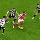 Gabriel Jesus of Arsenal runs with the ball under pressure from Tino Livramento, Sven Botman and Miguel Almirn of Newcastle United during the Carabao Cup Semi Final First Leg match between Arsenal and Newcastle United at Emirates Stadium on January 07, 2025 in London, England. (Photo by Alex Burstow/Arsenal FC via Getty Images)