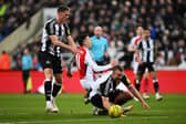 Gabriel Martinelli of Arsenal is challenged by Sven Botman (L) and Dan Burn of Newcastle United (R) during the Carabao Cup Semi Final Second Leg match between Newcastle United and Arsenal at St James' Park on February 05, 2025 in Newcastle upon Tyne, England. (Photo by Stu Forster/Getty Images)