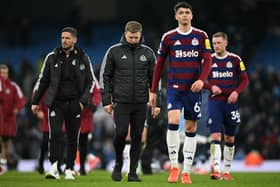Newcastle United's English head coach Eddie Howe (C) reacts on the pitch after the English Premier League football match between Manchester City and Newcastle United at the Etihad Stadium in Manchester, north west England, on February 15, 2025. Manchester City won the game 4-0. (Photo by Oli SCARFF / AFP)      