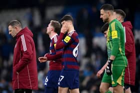 Lewis Miley of Newcastle United and his teammates look dejected after defeat in the Premier League match between Manchester City FC and Newcastle United FC at Etihad Stadium on February 15, 2025 in Manchester, England. (Photo by Stu Forster/Getty Images)